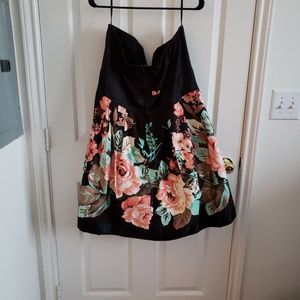 Strapless black dress with flower detail.